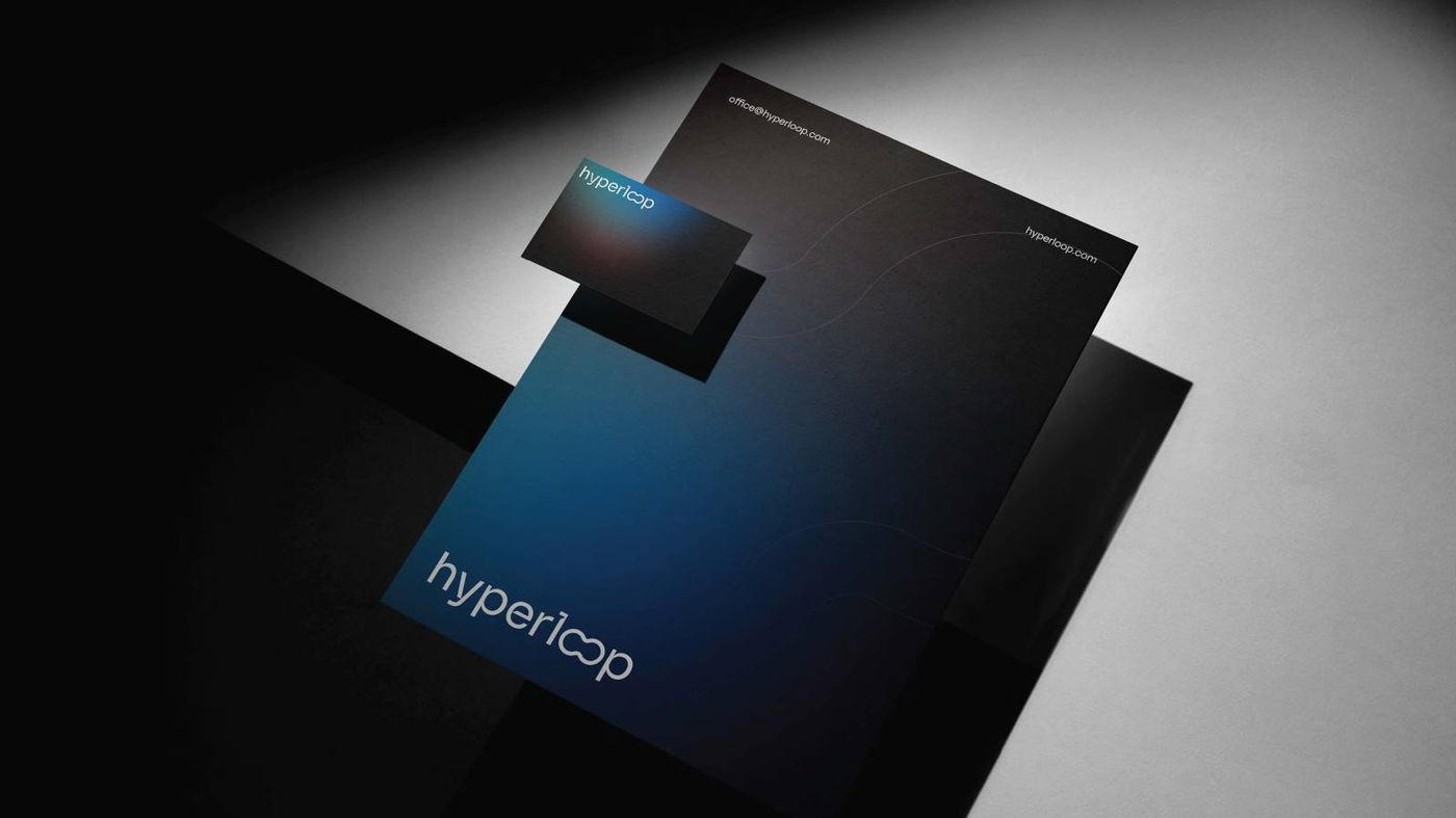 Letterhead and card, on the dark gradient ground.